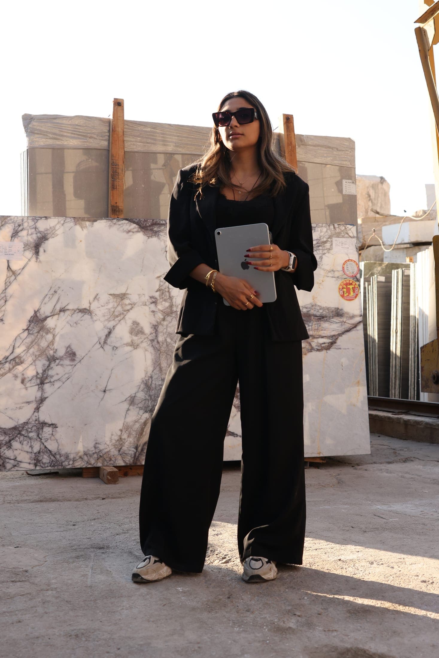 A Zein Group specialist with a tablet among the slabs at the Beirut stone yard