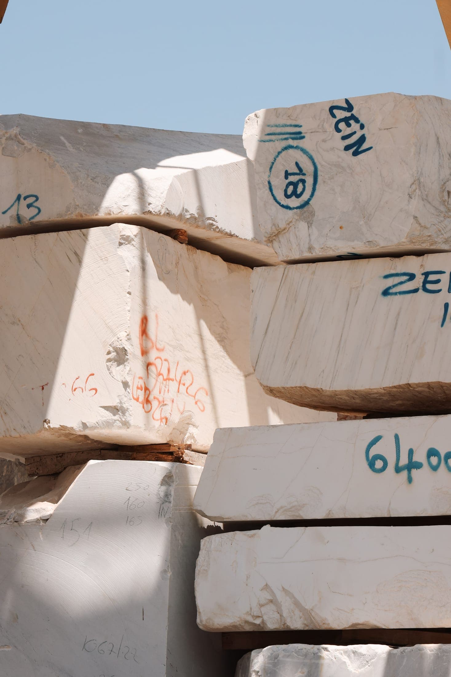 Marble blocks marked ZEIN stacked in the Zein Group yard, Beirut, before cutting