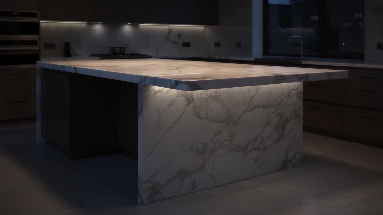 Calacatta marble waterfall island in a contemporary kitchen at dusk