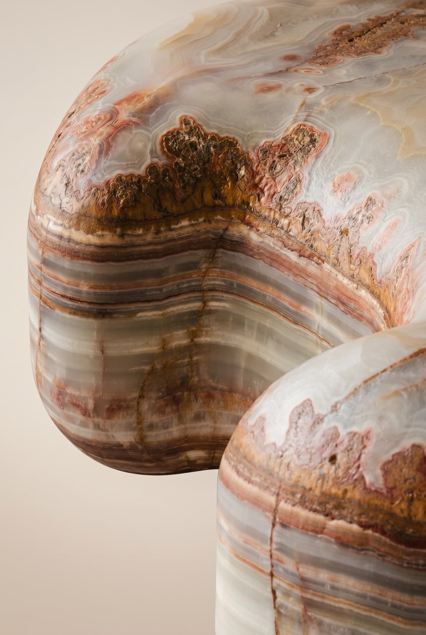 Banded agate onyx with concentric cream, grey, rust and amber layering