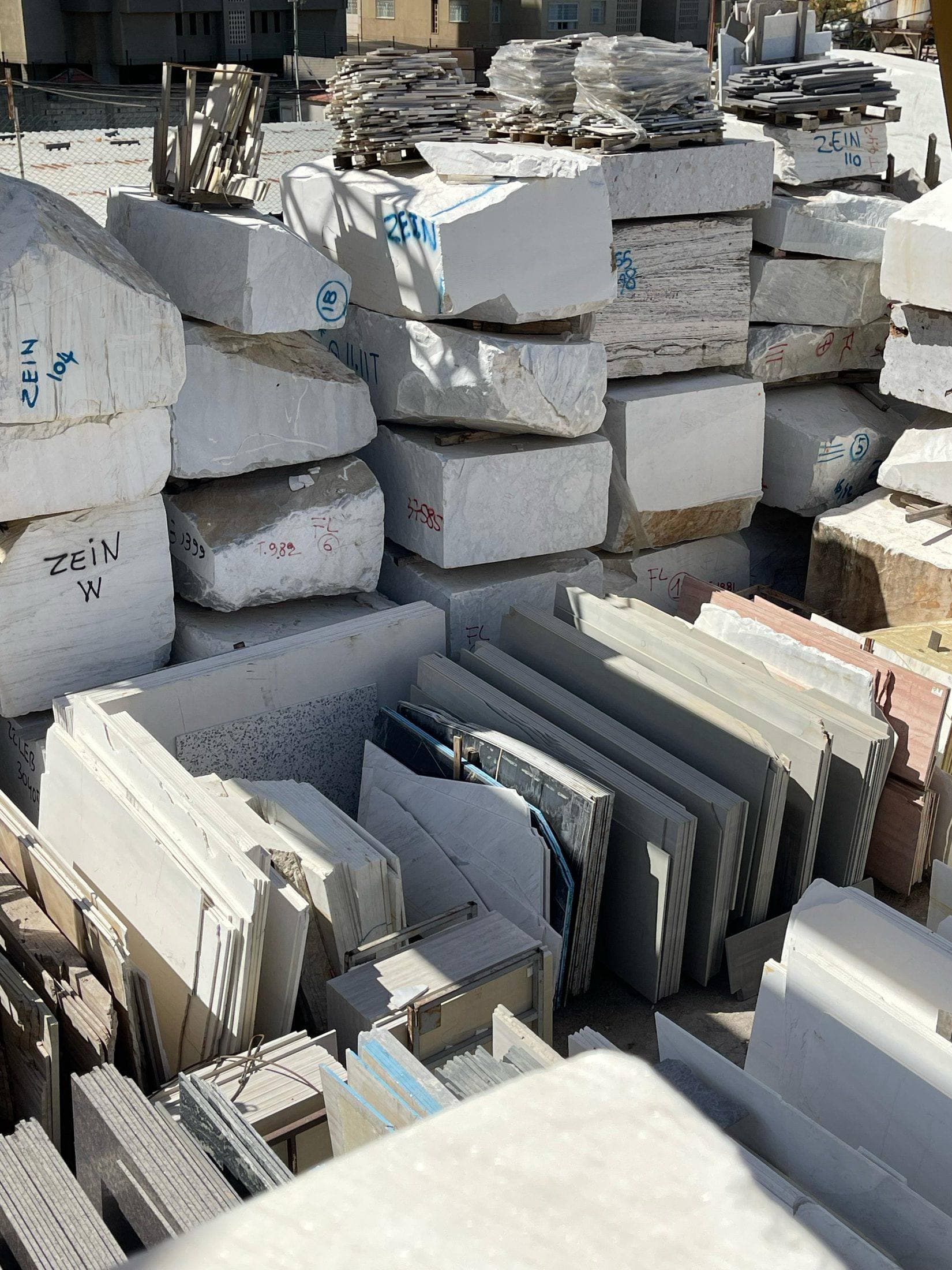 Rows of stone slabs racked in the Zein Group warehouse