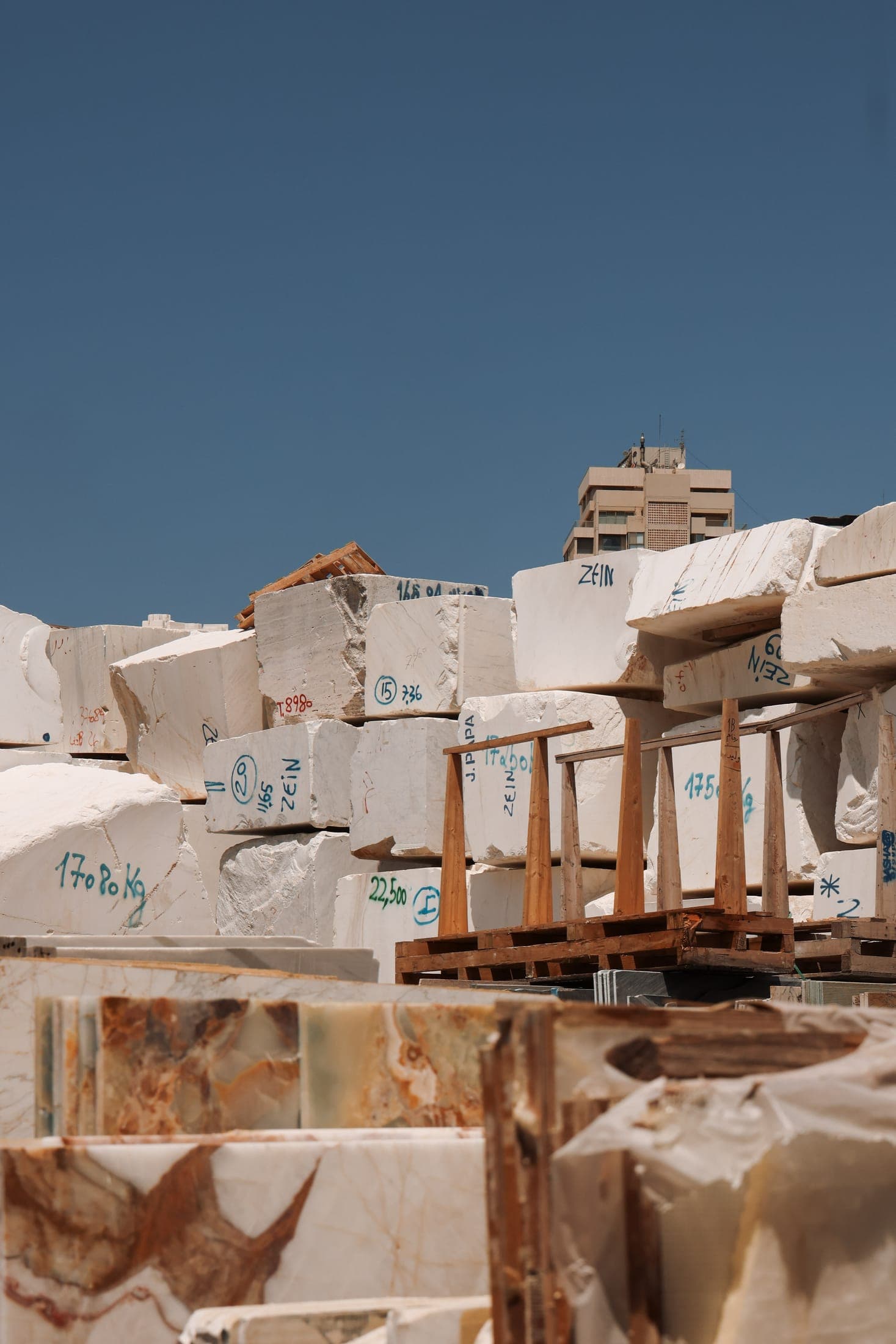 Marble blocks and slabs at the Zein Group stone yard against the Beirut skyline