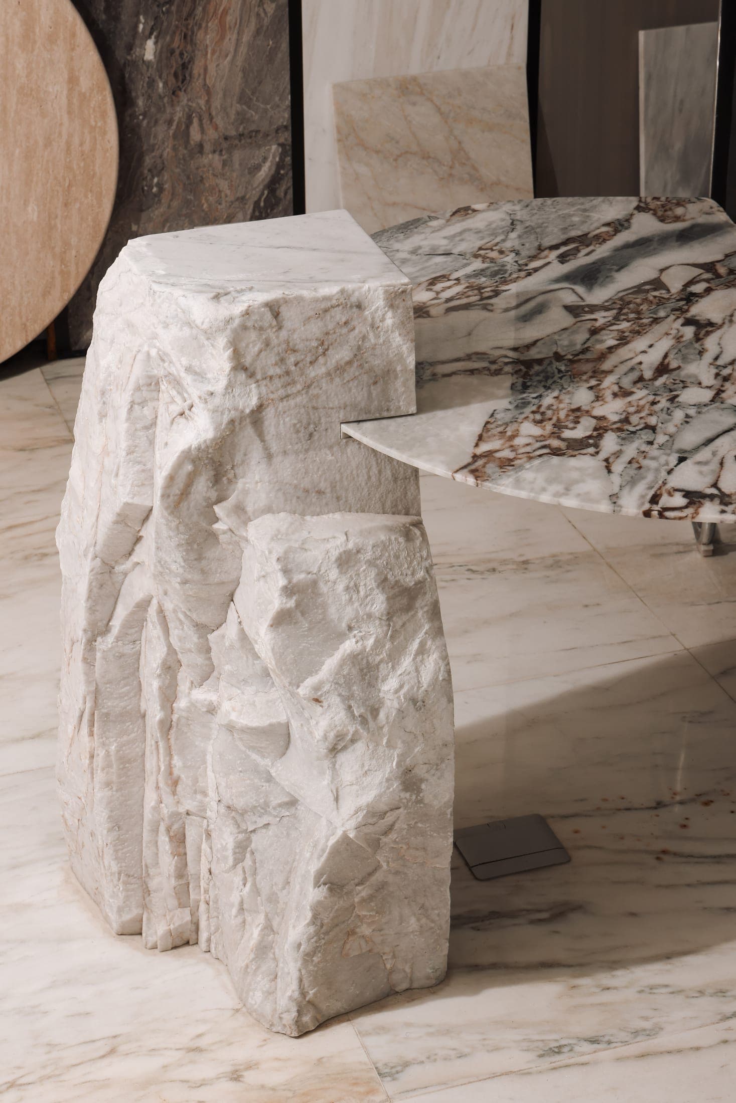 A bespoke console by Zein Group — a raw split block carrying a polished veined marble top