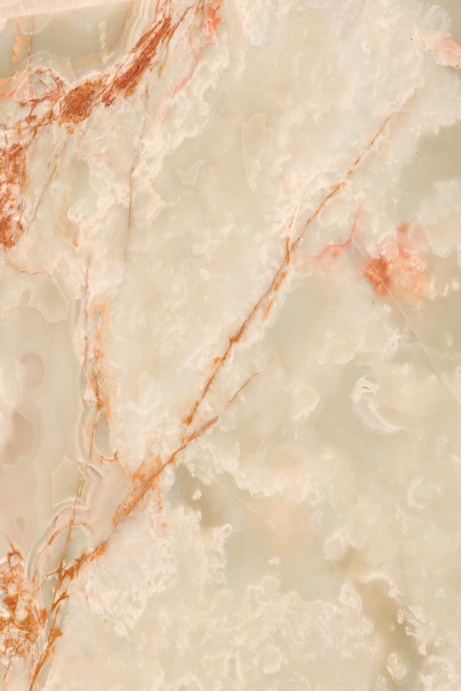 Close-up of a translucent cream slab with rust veining