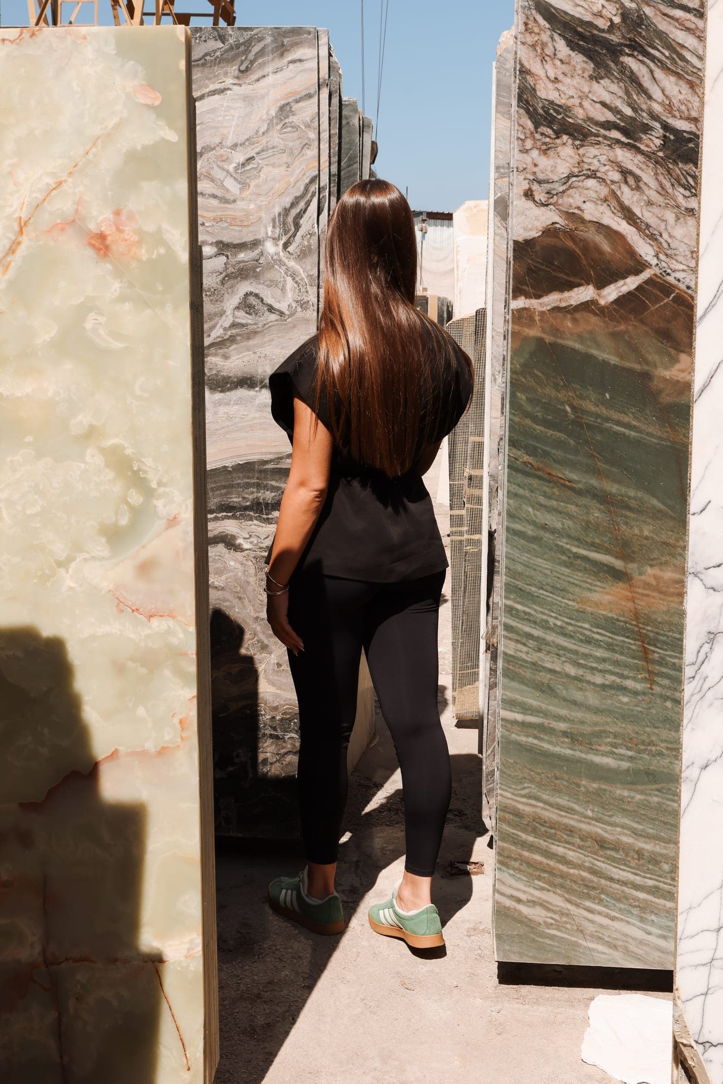 Walking between full-height slabs at the Zein Group showroom, Beirut